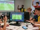 Football fans analyzing keobongdahomnay betting odds together in a lively environment.